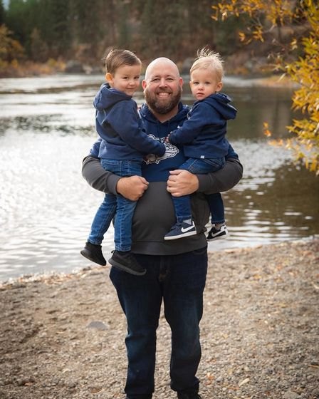 Joshua of MJ Construction Services with his two young sons by the river